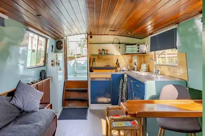 a kitchen and living room in a tiny house at Floating B&B Amsterdam in Amsterdam
