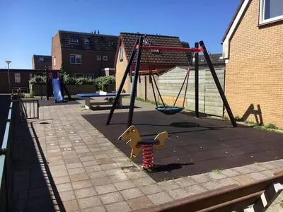 an empty playground with a swing at Strand83 in Egmond aan Zee
