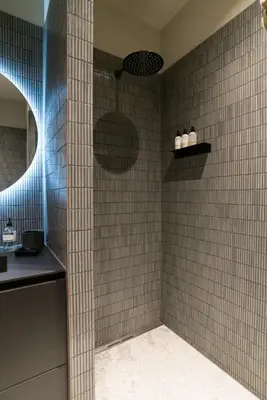 a bathroom with a shower with tiled walls at Vondel 99 in Amsterdam
