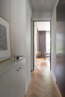 a kitchen with white walls and a wooden floor at Vondel 99 in Amsterdam