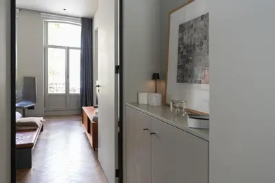 a room with a kitchen with a counter and a window at Vondel 99 in Amsterdam