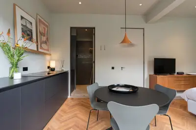 a kitchen and living room with a table and chairs at Vondel 99 in Amsterdam