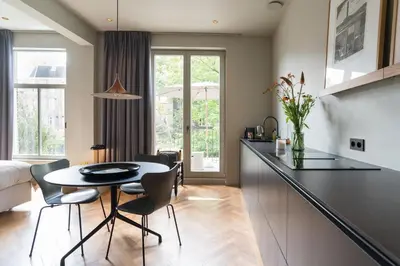 a kitchen and dining room with a table and chairs at Vondel 99 in Amsterdam