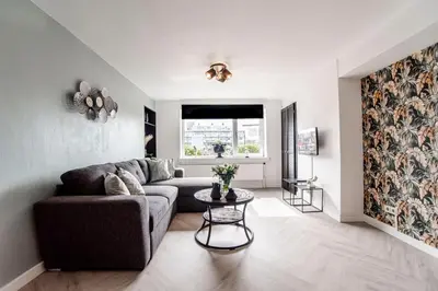 a living room with a couch and a table at Appartement en Studio Papillon in Zandvoort