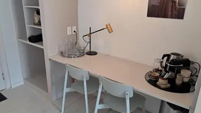 a desk with two chairs and a lamp on it at The Superstay Boutique guestroom in Amsterdam