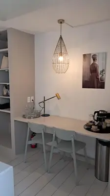 a table in a room with a light fixture at The Superstay Boutique guestroom in Amsterdam