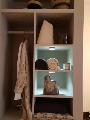 a book shelf with items on it in a room at The Superstay Boutique guestroom in Amsterdam