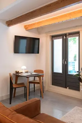a living room with a table and a tv at This Must Be The Place in Utrecht