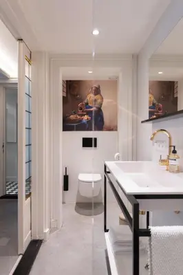a bathroom with a toilet and a painting on the wall at This Must Be The Place in Utrecht