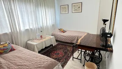 a room with two beds and a table and a piano at Two nice rooms in residential area with private bathroom in Almere
