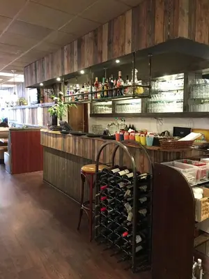 a kitchen with a bar with a bunch of wine bottles at Hotel Manofa in Amsterdam
