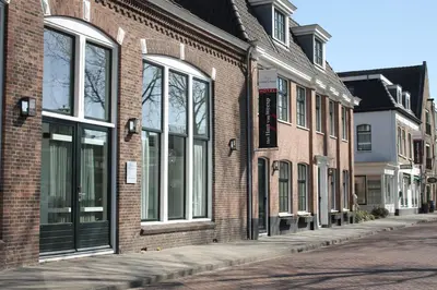 a row of brick buildings on a city street at Het Hart van Weesp in Weesp
