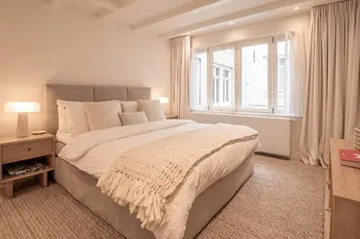 a bedroom with a large bed and a window at Elegant & unique canal house in famous canal area in Amsterdam