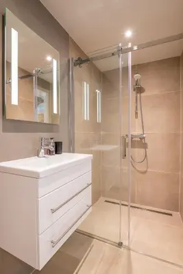 a bathroom with a white sink and a shower at Elegant & unique canal house in famous canal area in Amsterdam