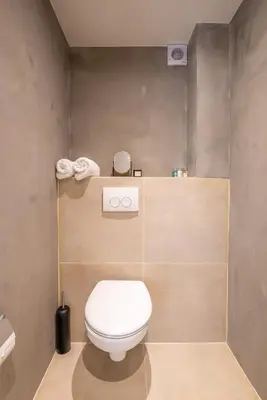 a bathroom with a white toilet in a room at Elegant & unique canal house in famous canal area in Amsterdam