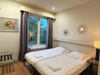 a bedroom with a bed and a window at CoronaZeist-Utrecht NL in Zeist