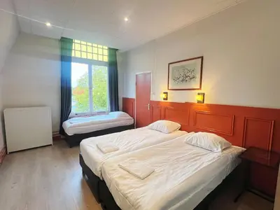 a room with two beds and a window at CoronaZeist-Utrecht NL in Zeist