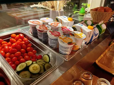 a buffet with tomatoes cucumbers and other food items at CoronaZeist-Utrecht NL in Zeist