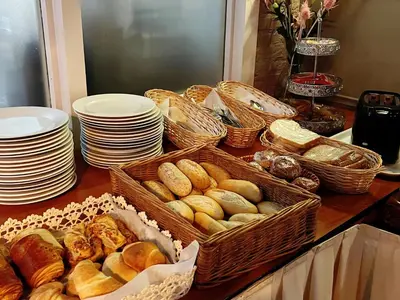 a table topped with baskets of bread and plates at CoronaZeist-Utrecht NL in Zeist