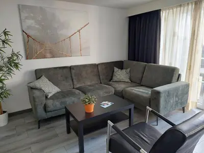 a living room with a couch and a table at Modern zomerhuis voor 4 personen in Wijk aan Zee