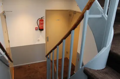 a stairwell with a fire extinguisheracistacistacistacist at Aston City Hotel in Amsterdam