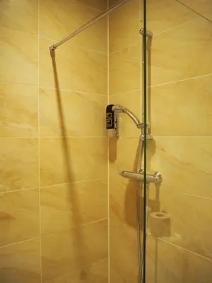 a shower with a glass door in a bathroom at Aston City Hotel in Amsterdam