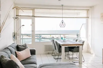 a living room with a table and a couch at Appartement Babette in Zandvoort