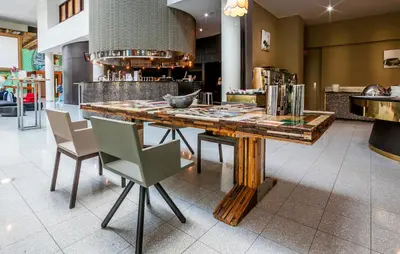 a large wooden table with chairs in a room at Hotel Artemis Amsterdam in Amsterdam