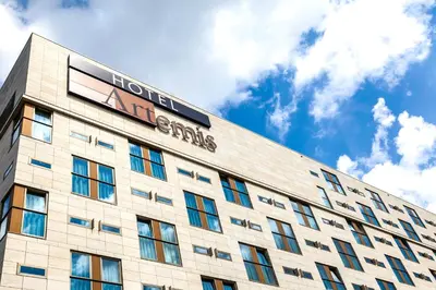 a building with a sign on the top of it at Hotel Artemis Amsterdam in Amsterdam