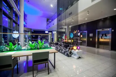 a lobby with a table and a couch in a building at Hotel Artemis Amsterdam in Amsterdam