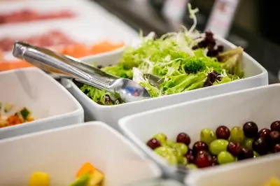 a group of trays filled with different types of food at Hotel Artemis Amsterdam in Amsterdam