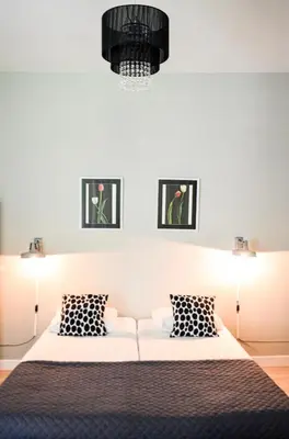 a bedroom with a bed with two pictures on the wall at Family Hotel Kooyk in Amsterdam