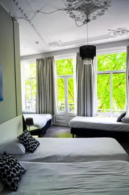 a room with two beds and two windows at Family Hotel Kooyk in Amsterdam