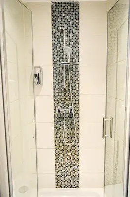 a shower in a bathroom with a glass door at Family Hotel Kooyk in Amsterdam