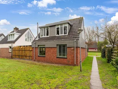 a red brick house with a gray roof at 