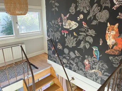 a staircase with a wallpaper with cats and birds at 