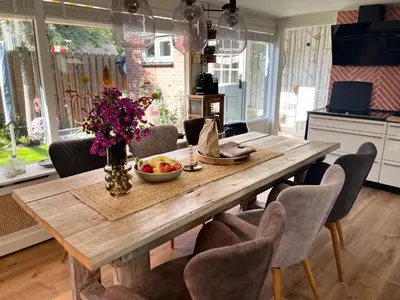 a dining room table with a bowl of fruit on it at 