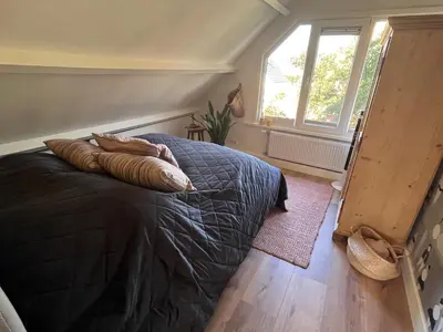 a bedroom with a bed with two pillows on it at 
