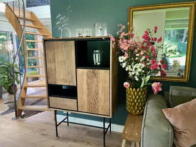 a entertainment center with flowers in a living room at 
