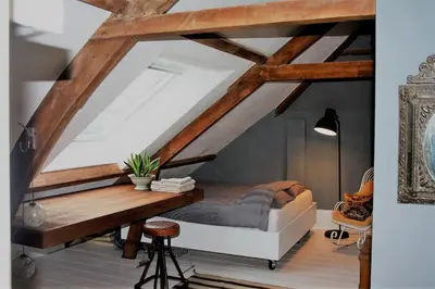 a bedroom with a bed and a wooden table at Farmhouse bohemian style close to Amsterdam in Waverveen