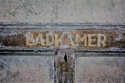 a rusty sign on a metal door with the word barrier at Farmhouse bohemian style close to Amsterdam in Waverveen