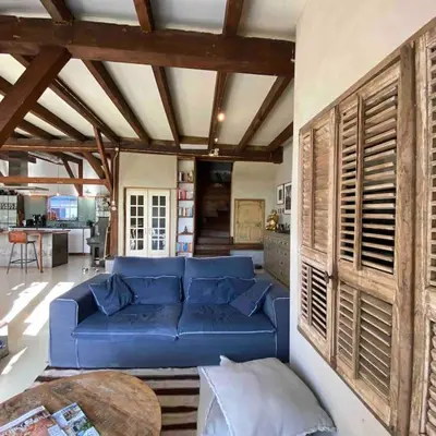 a living room with a blue couch and a table at Farmhouse bohemian style close to Amsterdam in Waverveen