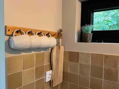 a bathroom with rolls of toilet paper on the wall at Duynbossie in Schoorl