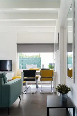 a living room with chairs and a table at -Casa Branca- nabij het meer, strand en keukenhof in Noordwijkerhout