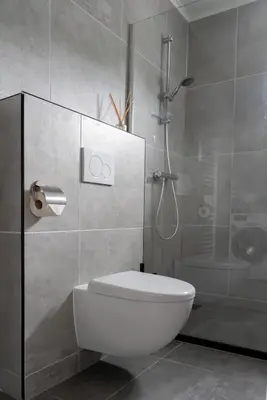 a bathroom with a white toilet and a shower at -Casa Branca- nabij het meer, strand en keukenhof in Noordwijkerhout