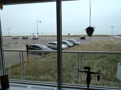 a shadow of a person standing in front of a window at Sterflat 39 in Egmond aan Zee