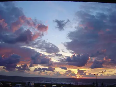 a sunset over the ocean with clouds in the sky at Sterflat 39 in Egmond aan Zee