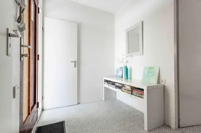 a white room with a table with books on it at Sterflat 53 in Egmond aan Zee