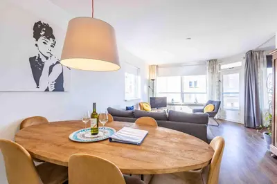 a living room with a table and a couch at Sterflat 53 in Egmond aan Zee
