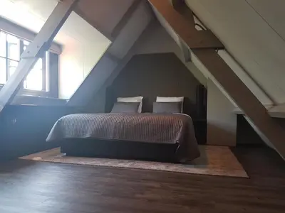 a bedroom with a bed in a attic at Fletcher Boutique Hotel Duinoord in Wassenaar